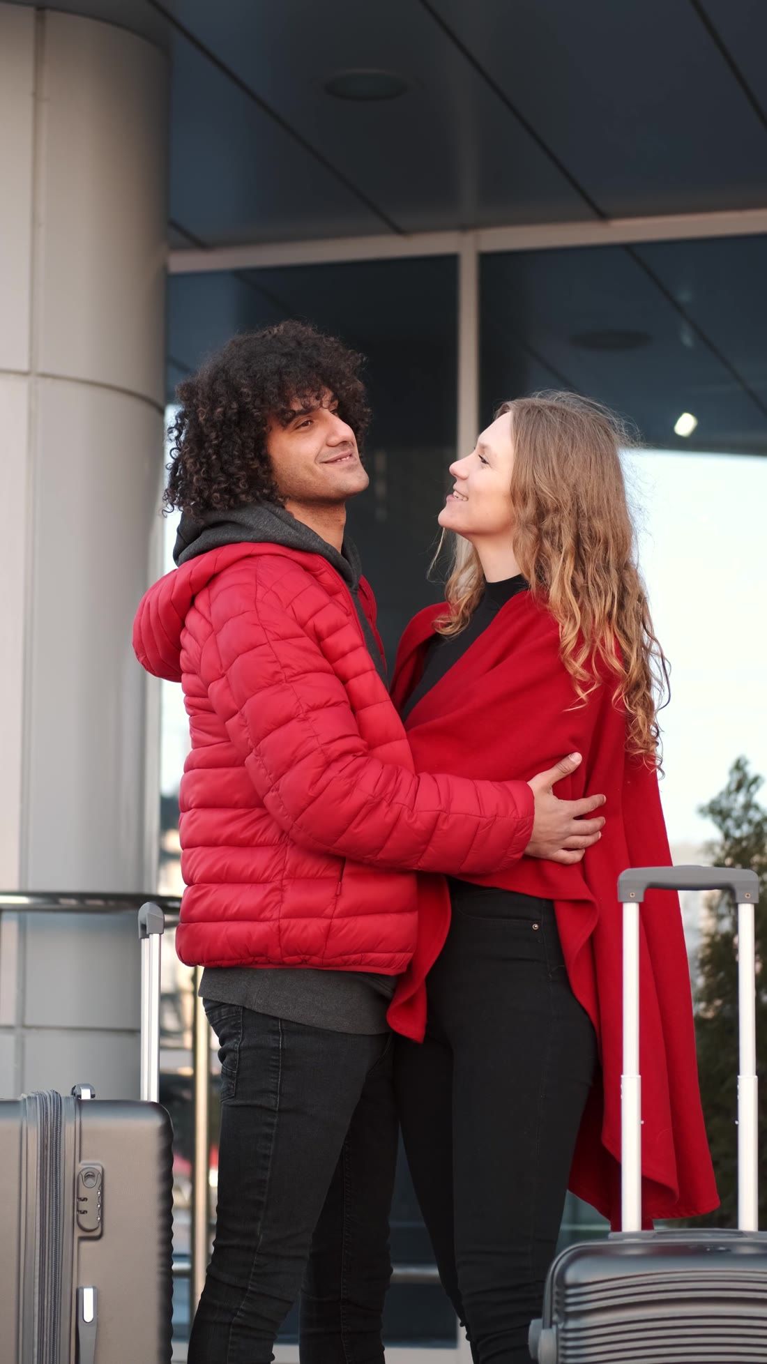 A couple hugging at an airport